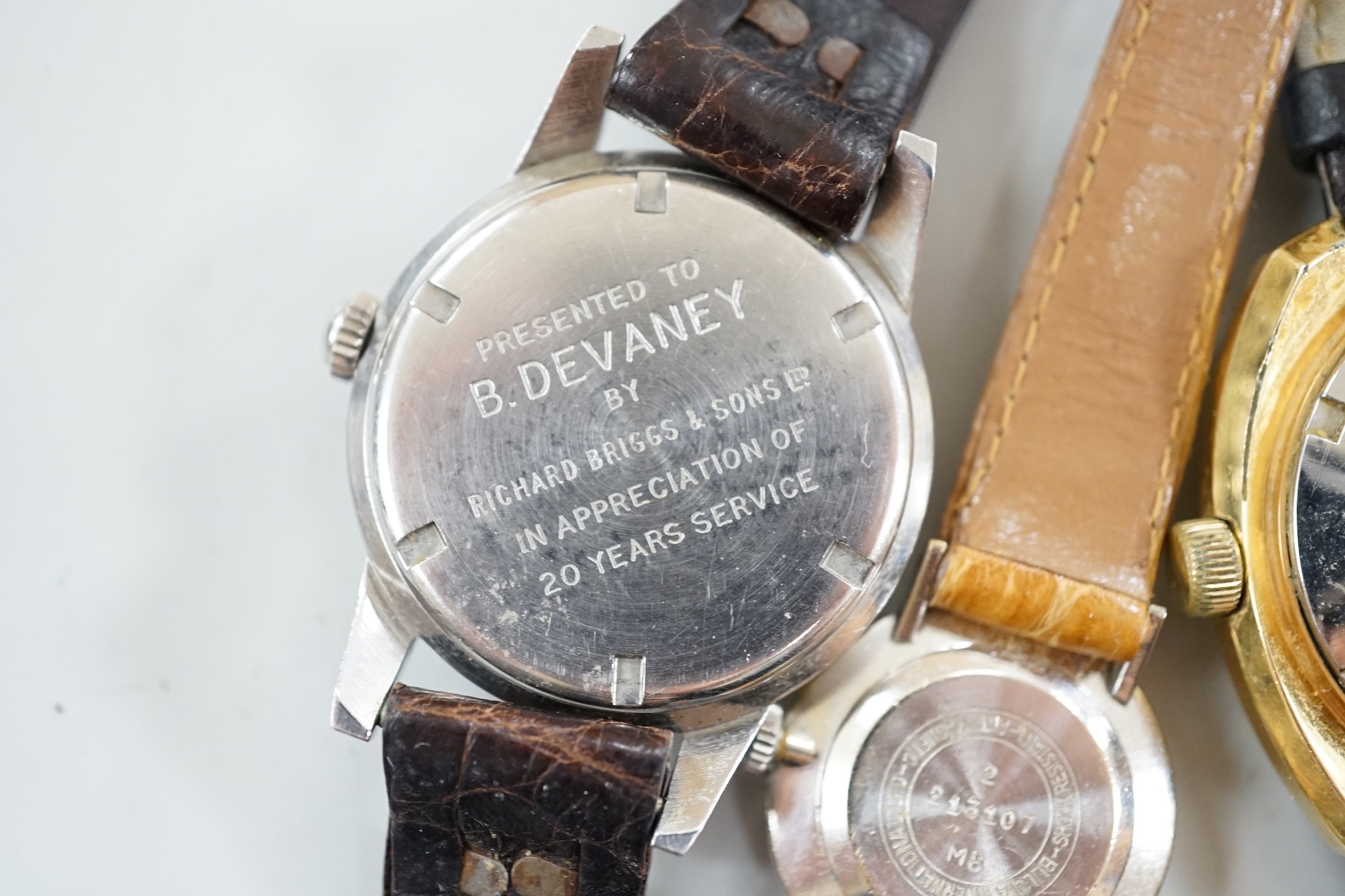 Three assorted gentleman's steel or gilt wrist watches, including retailed by Buhre and a lady's steel manual wind Bulova watch.